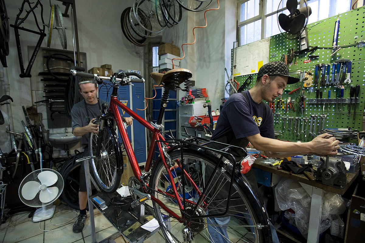 man repairs bike